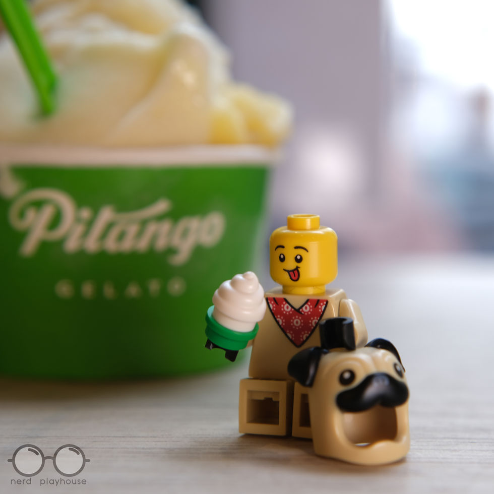 Creative photography of a LEGO minifig wearing a dog costume enjoying a cup of gelato