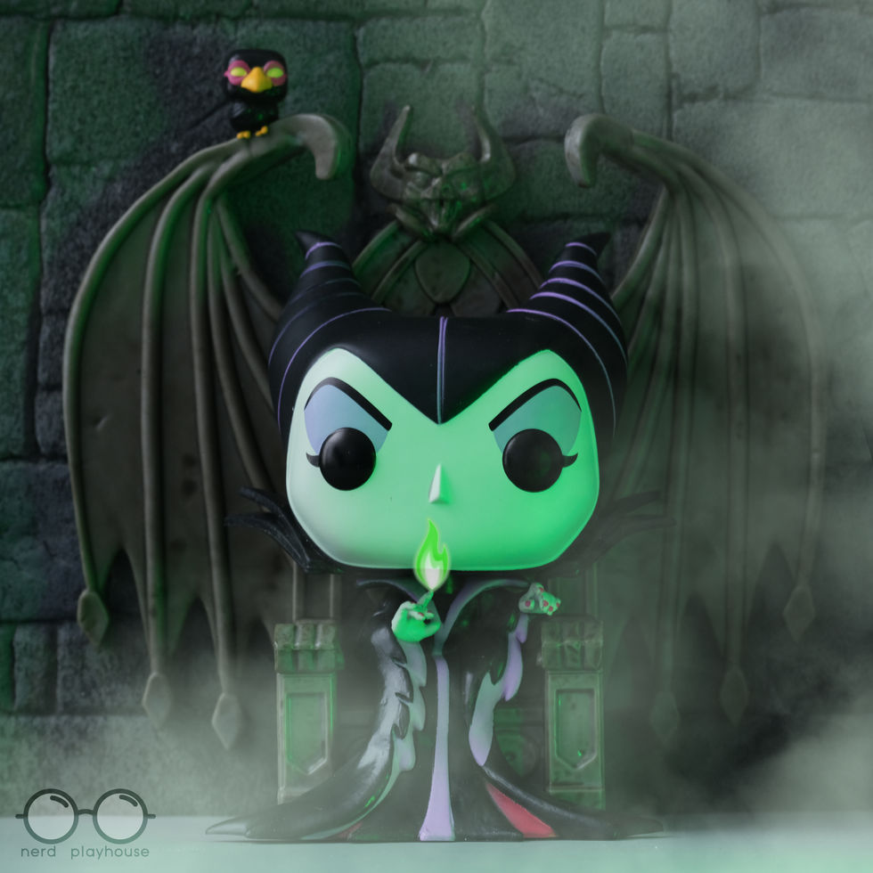 Creative toy photography of Funko POP Maleficent on her throne with a flame coming from her finger.