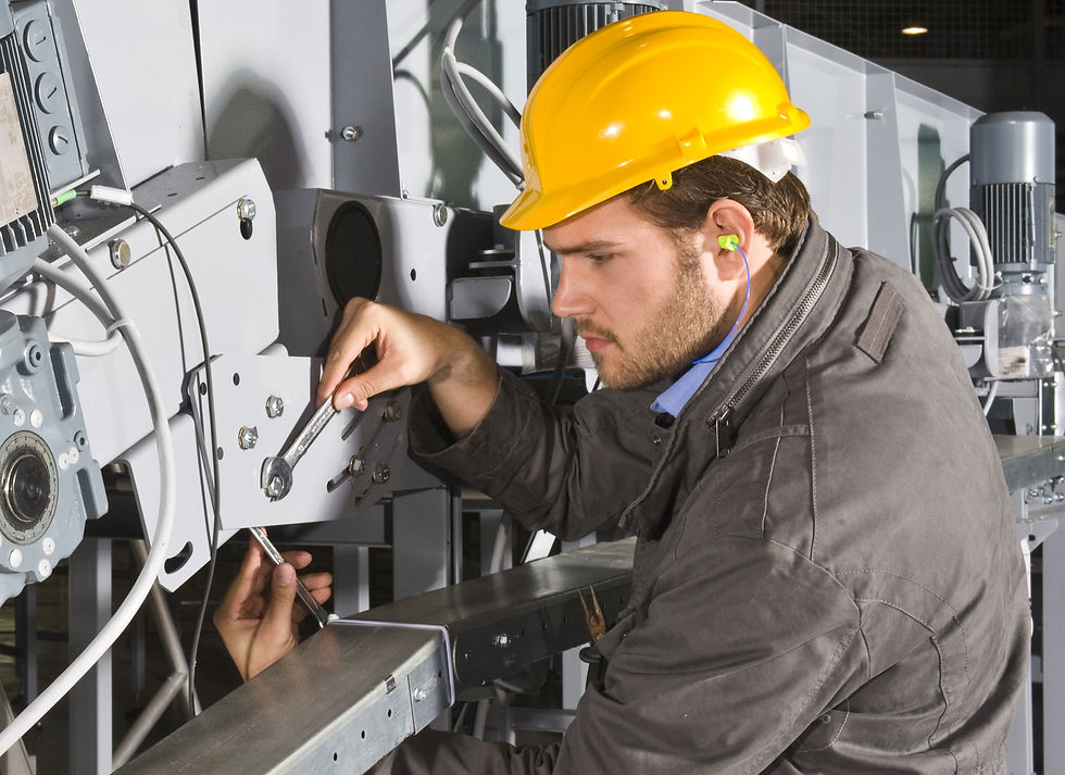 a maintenance engineer repairing some industrial equipment
