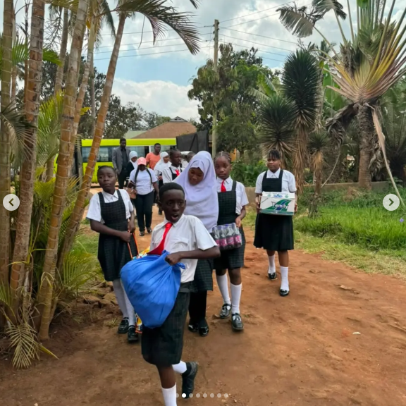 Eye-level view of pupils sharing donated items at a children’s care centre