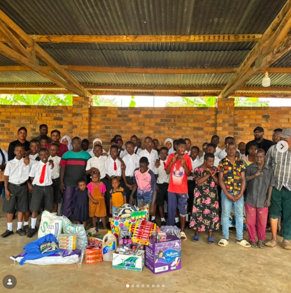 Wide-angle view of pupils and children gathered outdoors in Morogoro