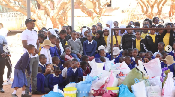 Eye-level view of pupils walking together with packed supplies.