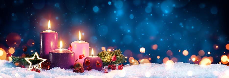 Four Advent candles on snow with a starry blue sky