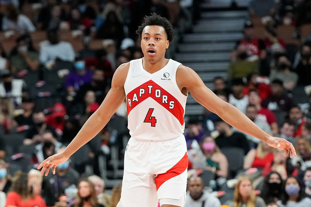 Toronto Raptors forward Scottie Barnes spreads his arms on defense after a made basket during an NBA basketball game.