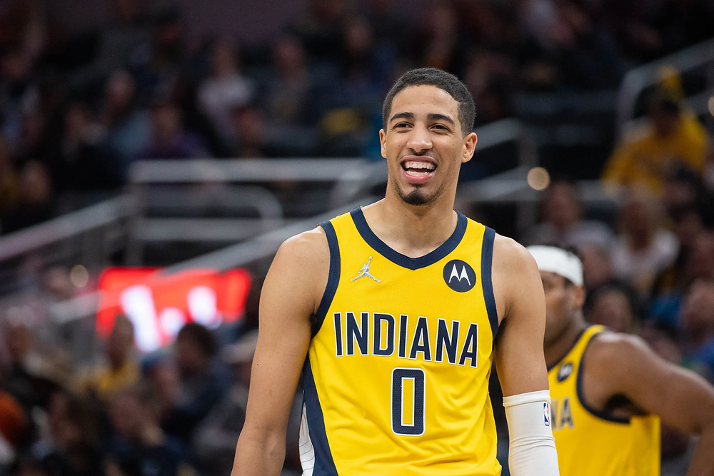 Indiana Pacers point guard Tyrese Haliburton smiles during a break in the action during an NBA basketball game.
