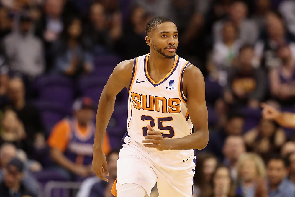 Phoenix Suns small forward Mikal Bridges runs up the court after a made basket during an NBA basketball game.