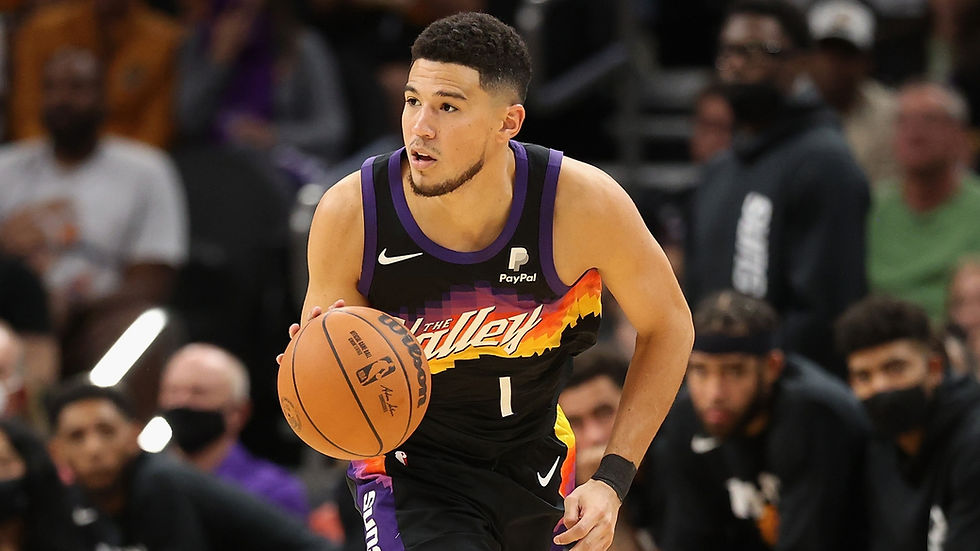 Phoenix Suns shooting guard Devin Booker dribbles the basketball on offense during an NBA basketball game.
