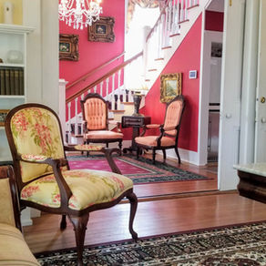 View from the historic downstairs parlor into the entrance hall at the Judge Porter House, a premier Louisiana bed and breakfast.