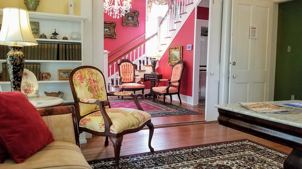 View from the historic downstairs parlor into the entrance hall at the Judge Porter House, a premier Louisiana bed and breakfast.