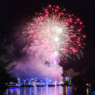 A panoramic view of the 100th Centennial fireworks and drone light show over the Cane River Lake from the Keyser Street Bridge in Natchitoches, Louisiana.