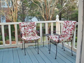 iew of the rear private deck overlooking the lush garden and fountain at a Louisiana bed and breakfast.