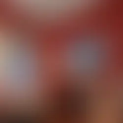 The grand red entrance hall and historic staircase at the Judge Porter House in Natchitoches.