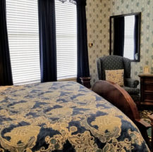 Cozy sitting area inside the Blue Room featuring comfortable chairs and historic charm.