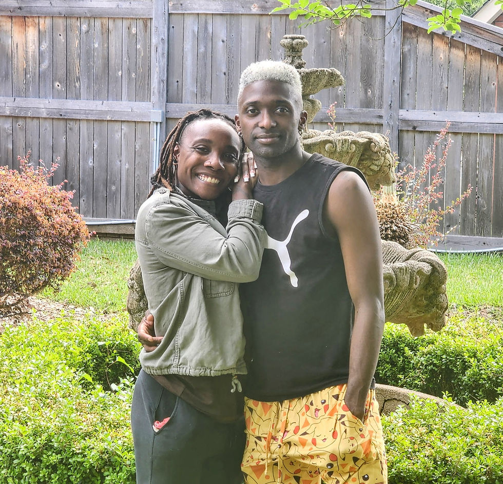 Duante and Aliyah smiling in front of the Lion fountain garden at the Judge Porter House Bed and Breakfast.
