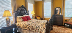 The carved queen-size bed in the Henry Guest Room