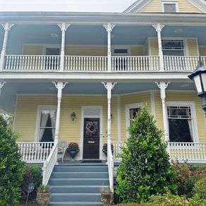A dramatic low-angle architectural photograph of the Queen Anne Bed and Breakfast front exterior.