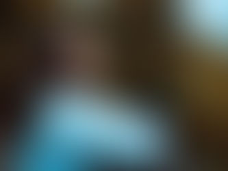 A woman with her eyes closed with trees in the background