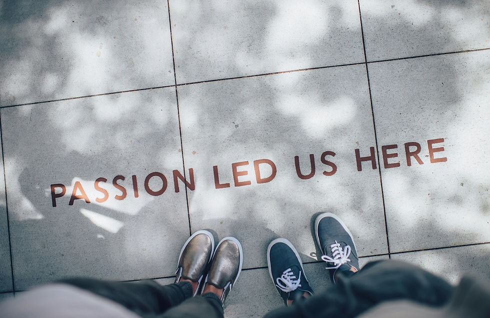 two pairs of feet standing next to a message on a street block that reads "Passion led us here". Blog post about founders establishing credibility in their business.
