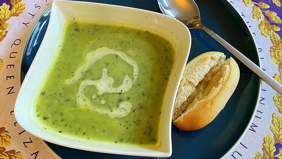 A delicious bowl of Courgette Zucchini Soup on a table cloth bought at Windosor Castle commemorating the queen's 70th jubilee.