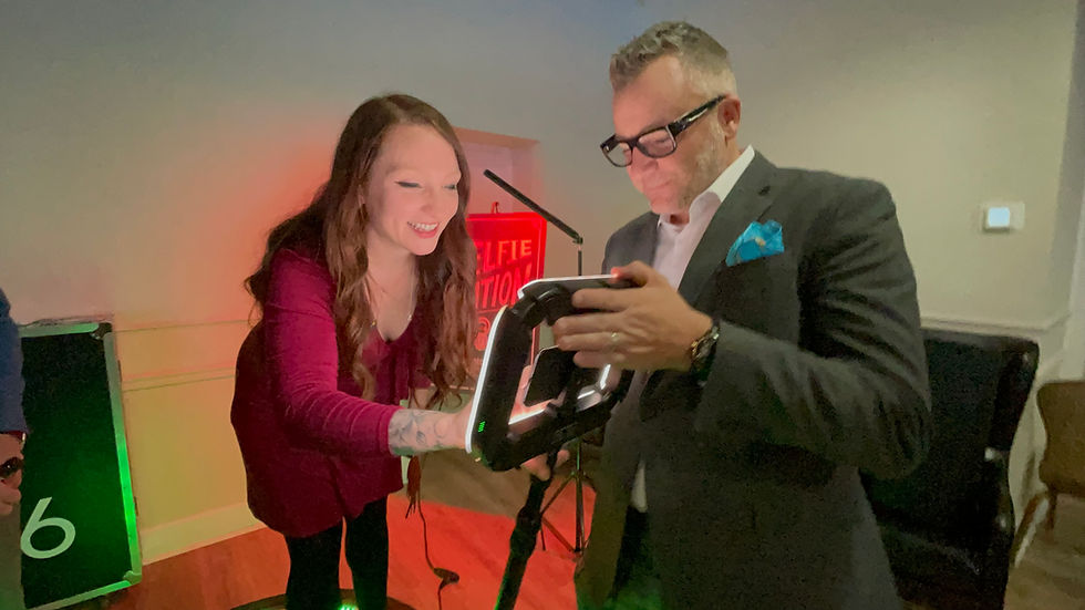 Close-up view of a DJ 716 tim mckeever with guest on 360-degree videobooth