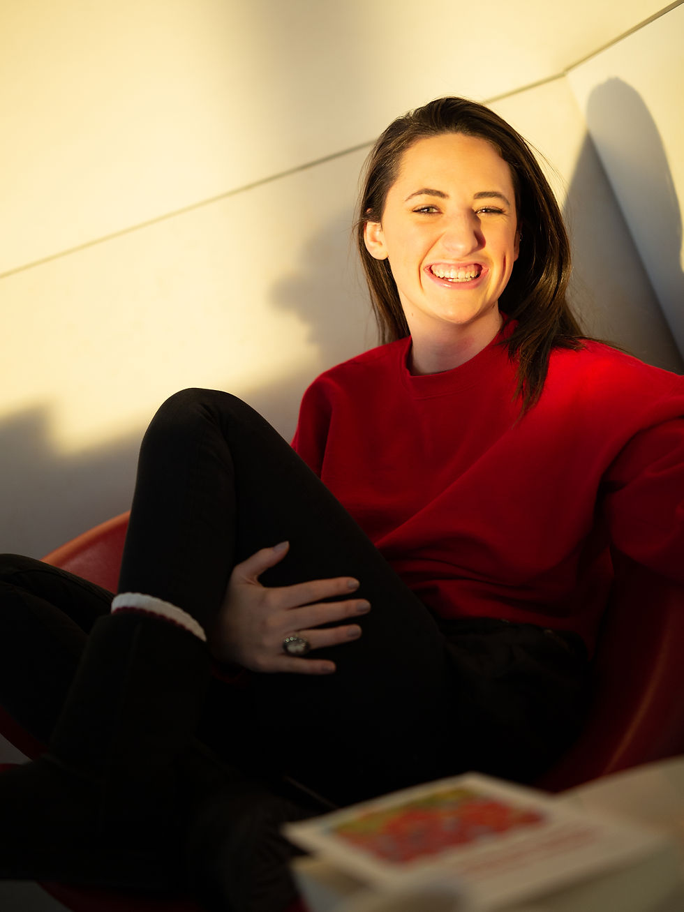 Photograph of Evelyn smiling in an airport.