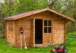 Garden shed with hoe, string trimmer,  rake and grass-cutter. Gardening tools shed. Garden