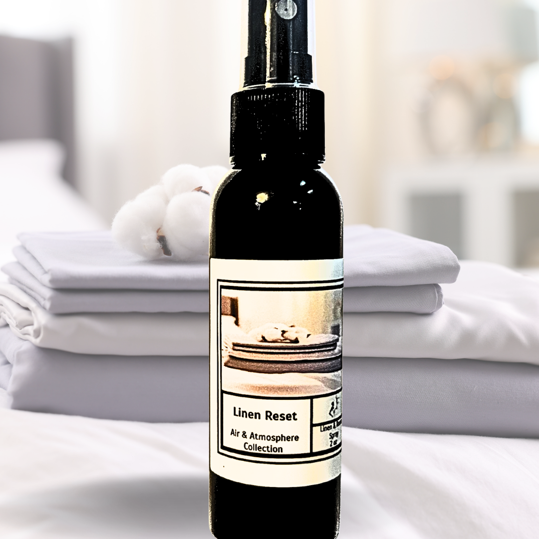 Linen Reset spray bottle on white folded linens with cotton boll