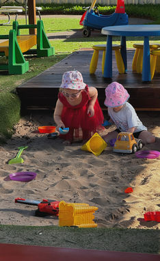 Toddlers and preschoolers playing in the sandpit at Kidzspot Ornella in Glendenning.