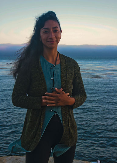 Sarah by the ocean smiling.