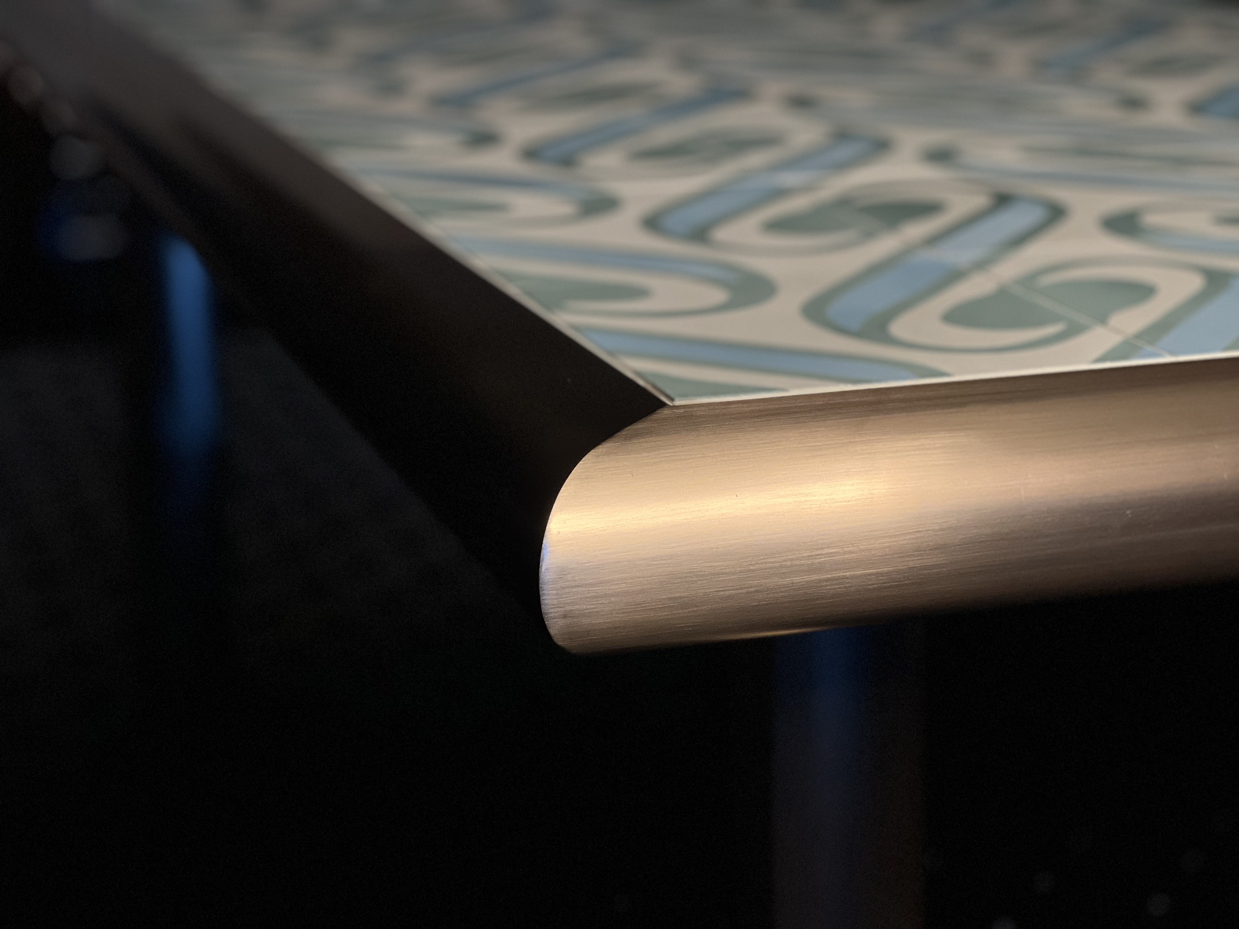 Corner shot of a custom brass table. 