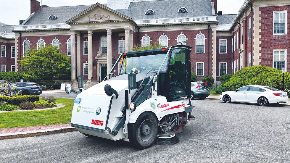 An operator uses an Elgin Pelican sweeper to clean debris from a roadway as part of the DPW’s daily street maintenance program.