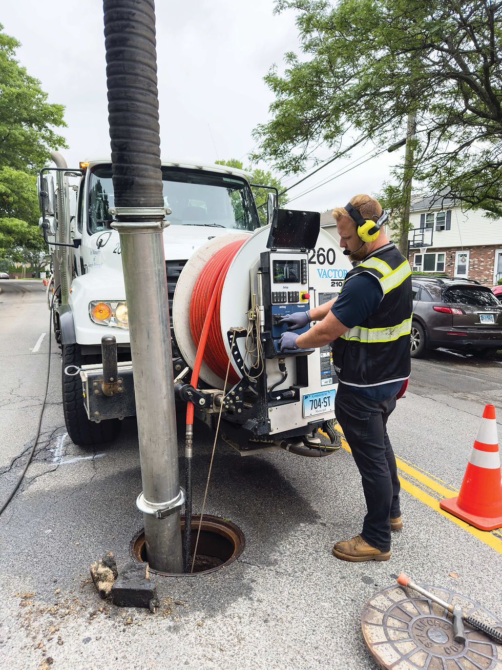 Liam Kenny operates a Vactor 2100i combination sewer cleaner via a control panel.