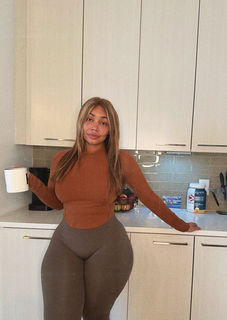Candice Mary in a fitted gym outfit making coffee at home, featuring Amazon outfit and coffee maker from her morning routine