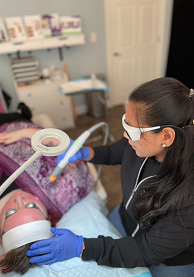 Photo of Dr. Cardona performing laser genesis.