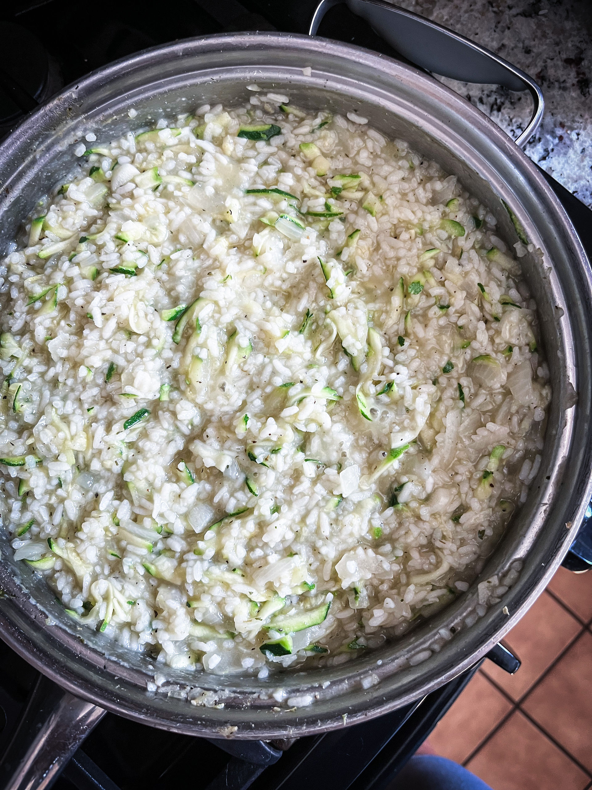 Ingredients for  herby veggie risotto.  Celery, garlic, lemon, rice, zucchini, peas, spinach, asparagus over arugula with parsley.  Rhode Island Personal Chef In home wellness chef