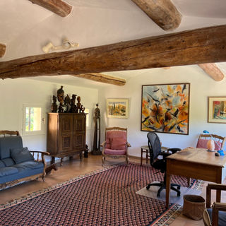 Charming Provençal office and sitting room on the second storey with exposed wood beams and panoramic Luberon mountain views at a luxury villa near Lourmarin.