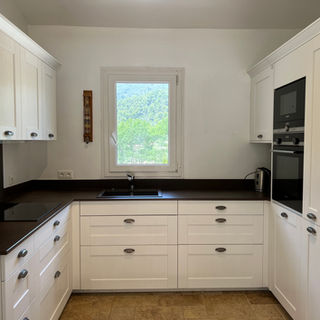 Bright, fully equipped kitchen overlooking the Luberon mountains in a Vaugines holiday villa.