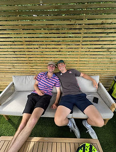 Two club members relaxing courtside between games