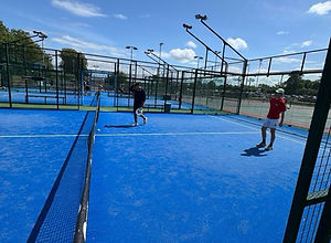 Doubles match in progress on a sunny padel court