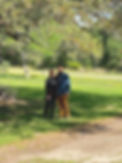 Joy and Mike standing beneath an old oak tree on their property.