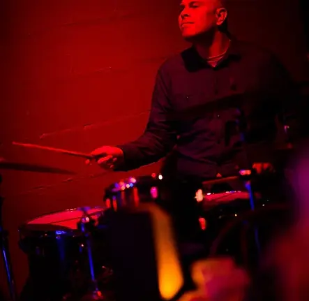 Photo of Kenny Shaw playing drums at a show