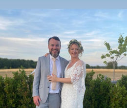 Bride & Groom, Emily & Jack, pose for a photography infront of their countryside wedding venue
