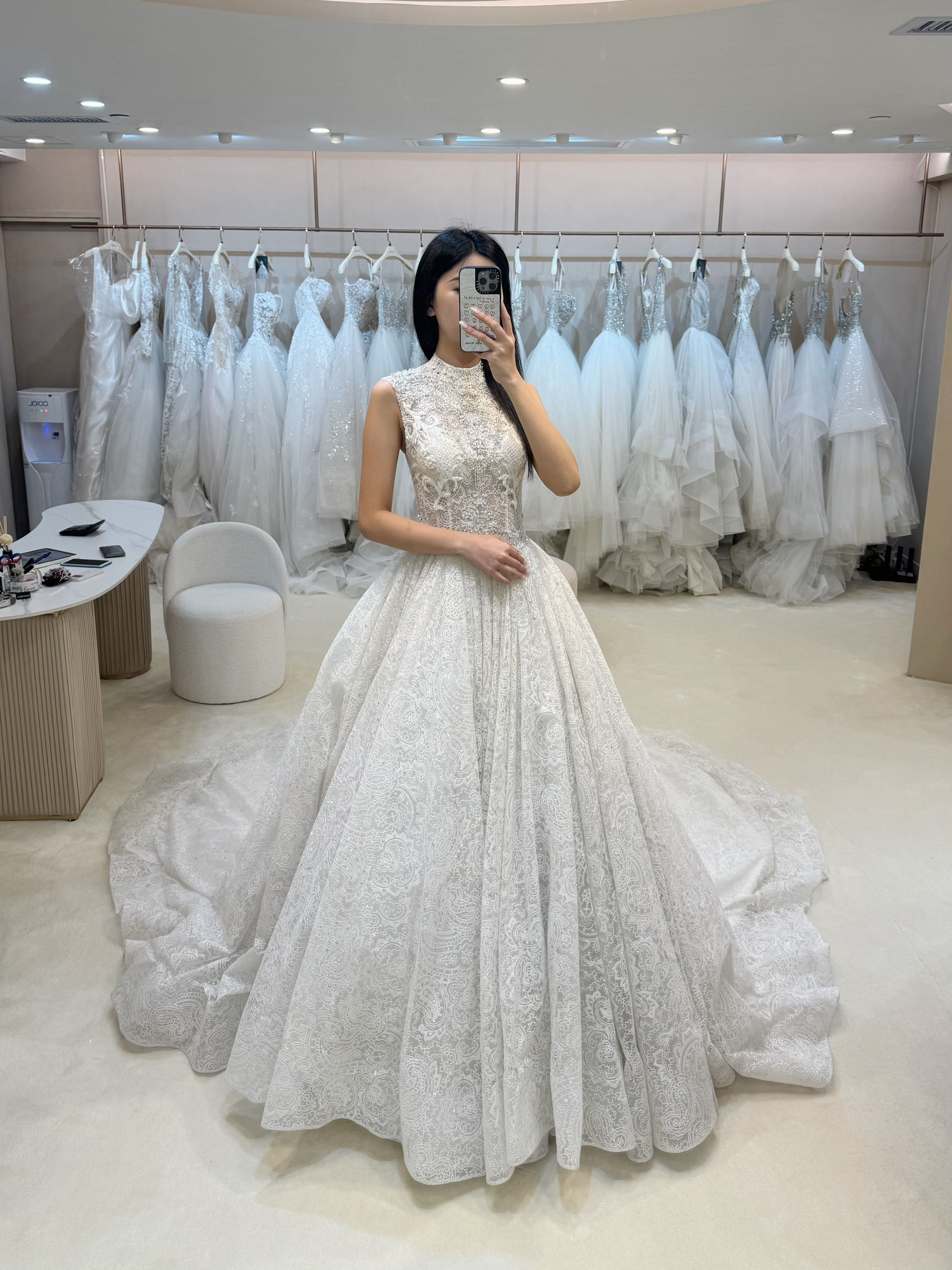 White lace wedding gown with high neckline and long train