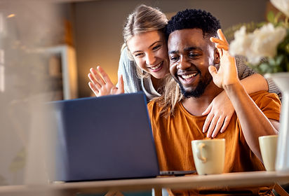 smiling-young-mixed-couple-using-a-laptop-for-vide-2026-01-07-07-08-44-utc.jpg