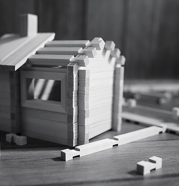 wooden-house-building-blocks-on-a-wooden-table-2026-03-26-08-49-55-utc.jpg