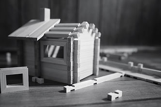 wooden-house-building-blocks-on-a-wooden-table-2026-03-26-08-49-55-utc.jpg
