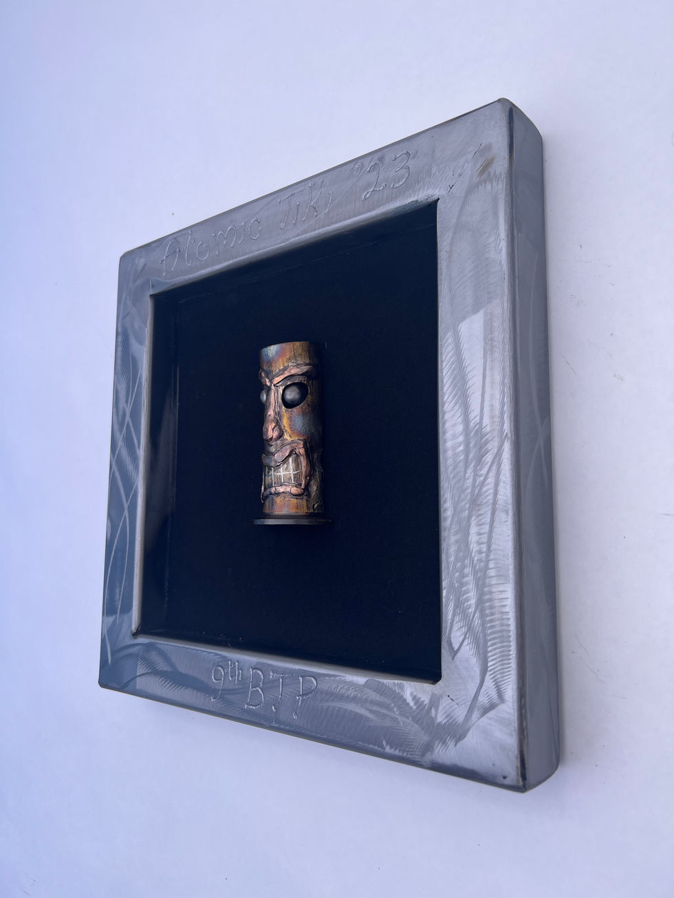 Small tiki in frame with a black background