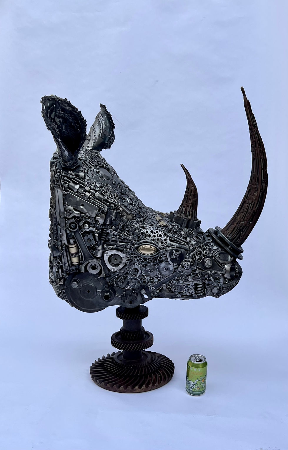Right facing rhinoceros head, Made from a lot of retired tools and hardware. The horns are forged bolts that have a patina applied to make them stand out from the rest of the sculpture. Beer can for scale.