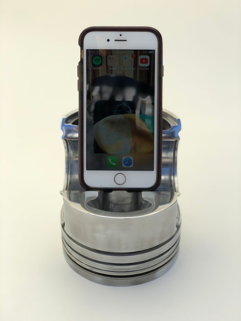 Phone or tablet holder made from a polished piston out of a semi truck engine