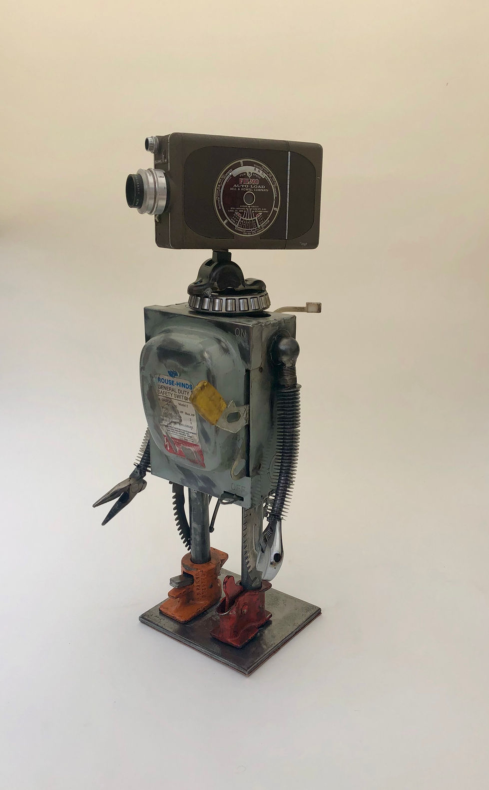 Vintage video camera headed robot. Heavy electrical switch for the body and cooling coils for the arms